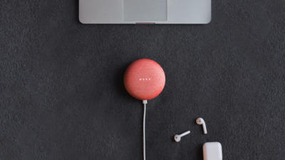 overhead shot of a computer, speaker, and headphones